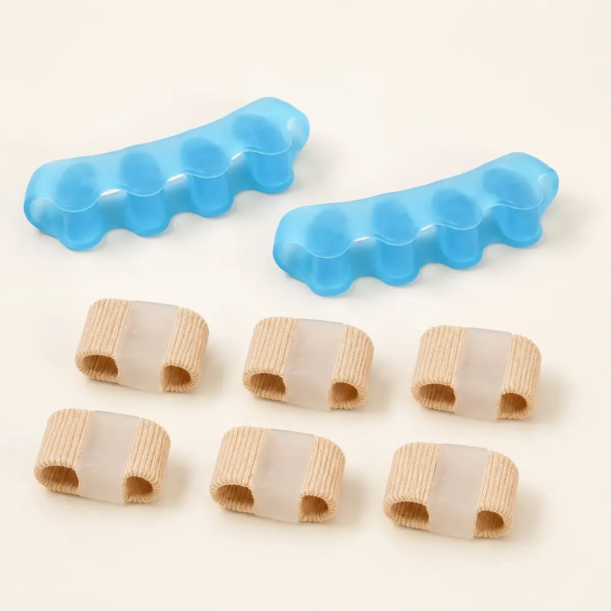 Flat lay of the complete kit: a pair of blue gel spacers and six beige fabric separator tubes